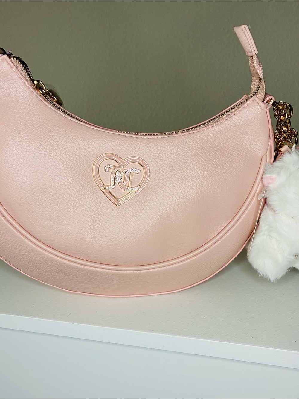 Juicy Couture Light Pink Crescent Shoulder Bag with Heart Logo and charm.